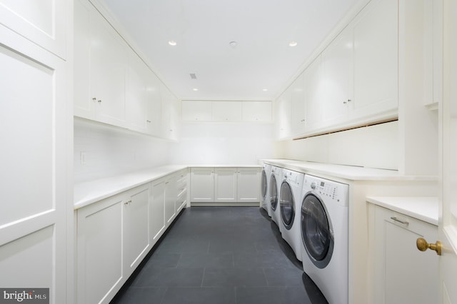 washroom with cabinets and washer and clothes dryer