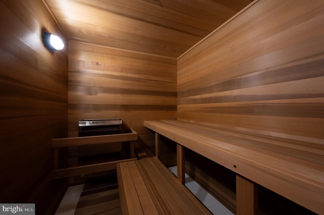 view of sauna / steam room featuring wooden walls and wood ceiling