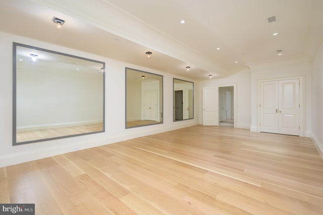 spare room featuring crown molding and wood-type flooring