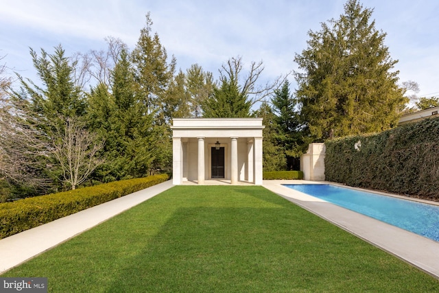 view of swimming pool with a yard