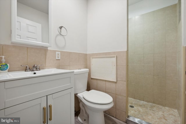 bathroom featuring walk in shower, vanity, tile walls, and toilet