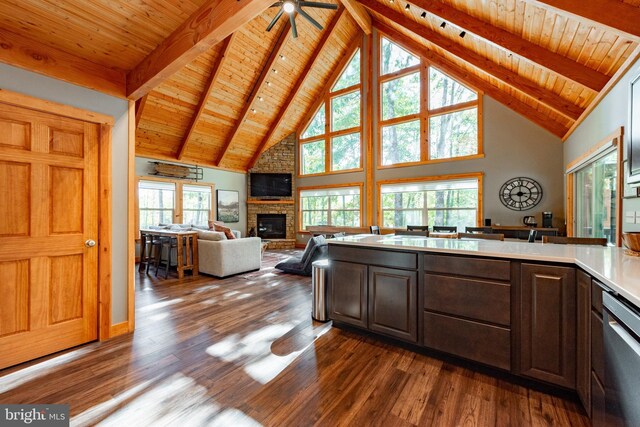 kitchen featuring wooden ceiling, dark brown cabinetry, ceiling fan, and a brick fireplace