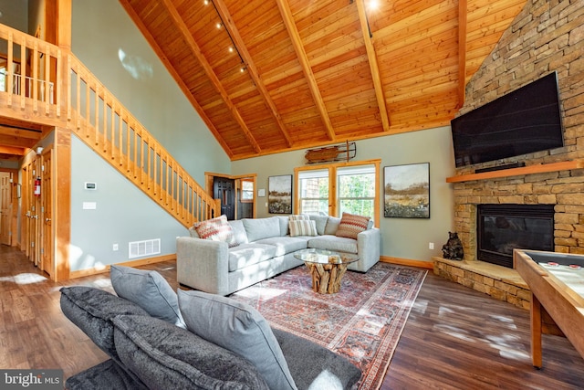 living room with wood ceiling, a fireplace, hardwood / wood-style floors, and high vaulted ceiling