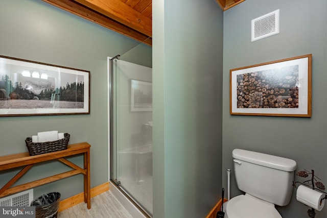 bathroom with lofted ceiling with beams, wood-type flooring, walk in shower, and toilet