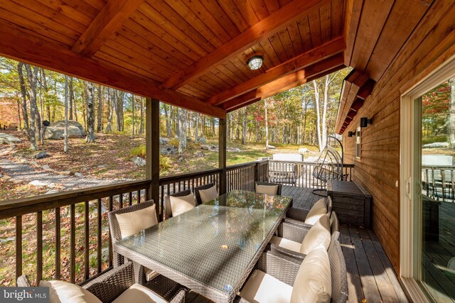 wooden deck featuring outdoor dining space