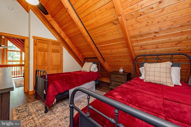 bedroom with vaulted ceiling with beams, wooden ceiling, and dark wood-type flooring