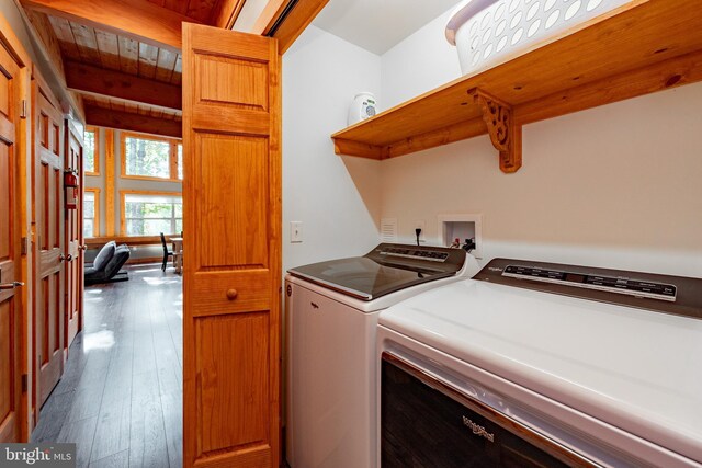 laundry area featuring wood ceiling, washing machine and dryer, and dark hardwood / wood-style floors