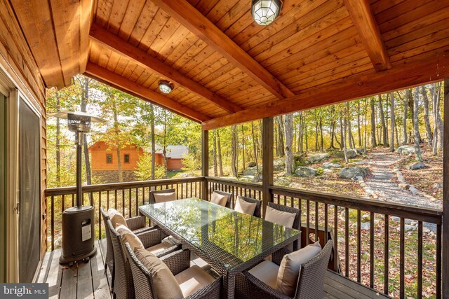 sunroom with vaulted ceiling with beams and wood ceiling