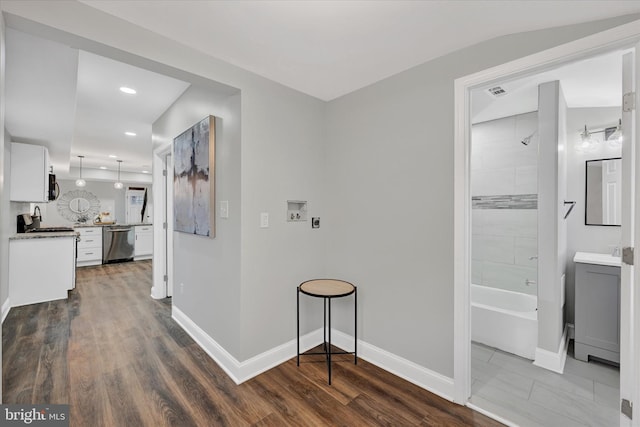 hallway with dark hardwood / wood-style floors and sink