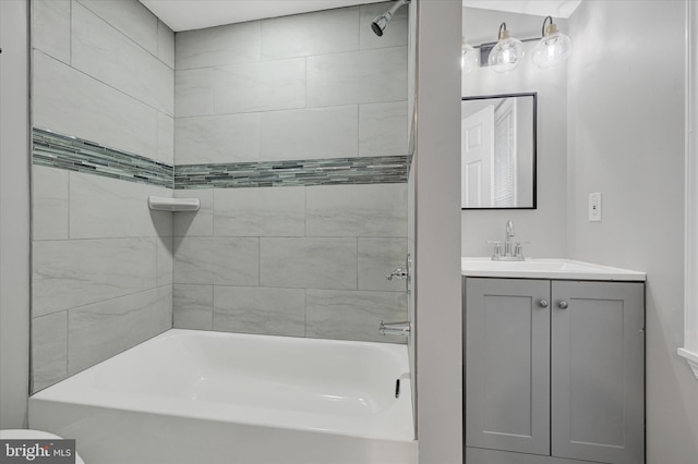 bathroom featuring vanity and tiled shower / bath