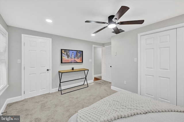 bedroom with ceiling fan and light colored carpet