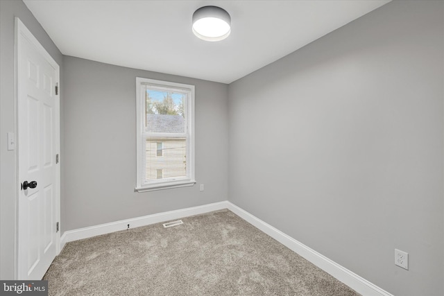 spare room with light colored carpet