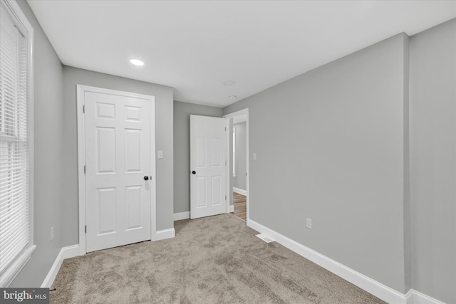 unfurnished bedroom featuring light colored carpet