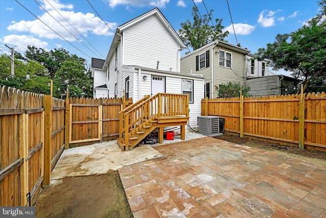 rear view of property featuring cooling unit and a patio