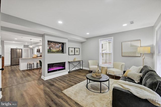 living room with dark hardwood / wood-style flooring