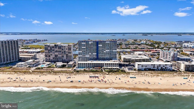 aerial view with a water view and a beach view