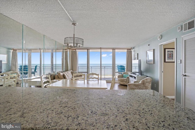 kitchen with a textured ceiling and floor to ceiling windows