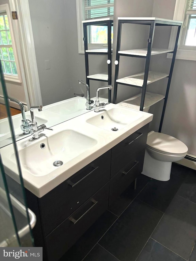 bathroom with vanity, tile patterned floors, and toilet