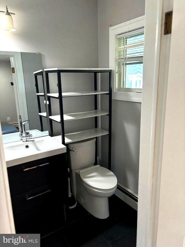 bathroom with vanity, tile patterned floors, and toilet