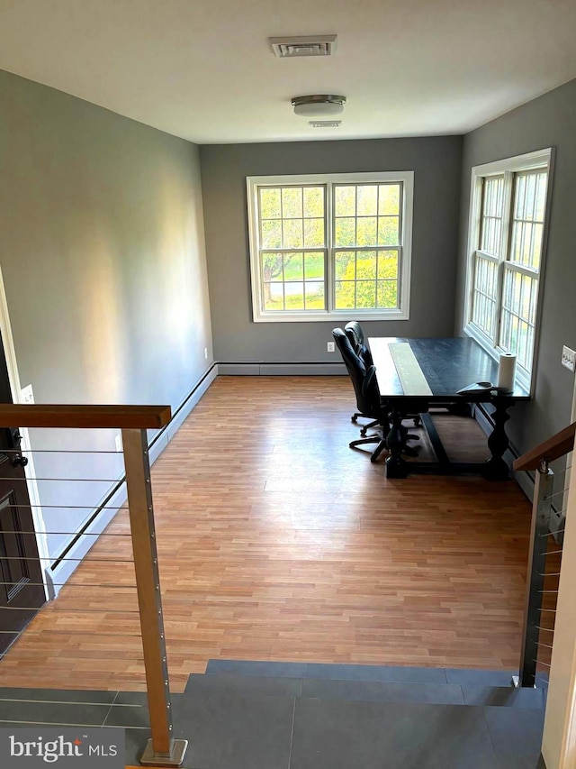 unfurnished dining area featuring hardwood / wood-style floors