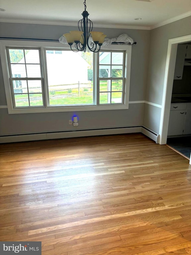 unfurnished dining area featuring crown molding, light hardwood / wood-style flooring, a chandelier, and baseboard heating