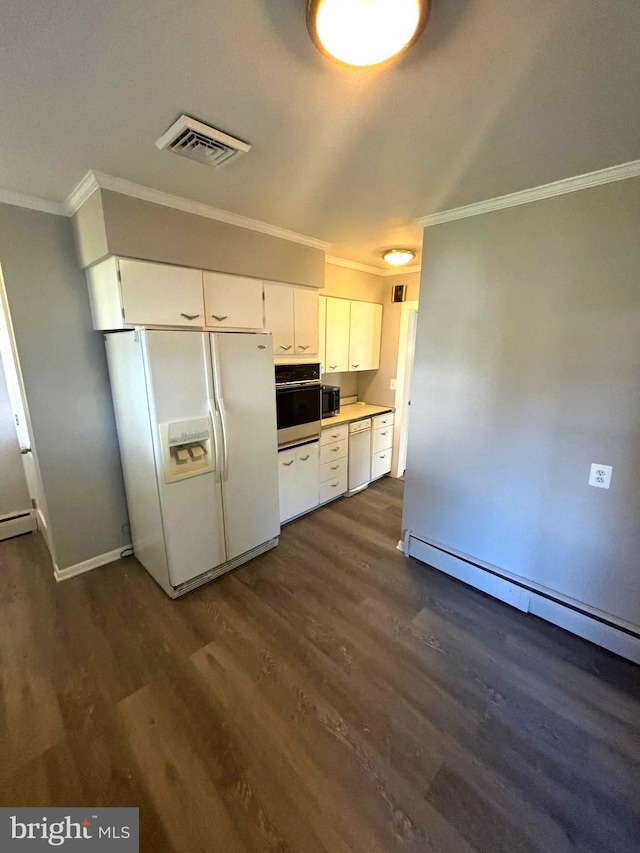 kitchen featuring a baseboard radiator, stainless steel appliances, dark hardwood / wood-style floors, and white cabinets