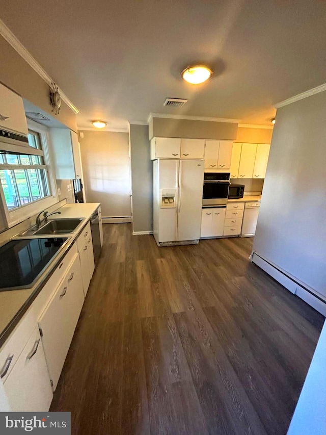 kitchen featuring sink, white cabinets, a baseboard heating unit, black appliances, and dark wood-type flooring