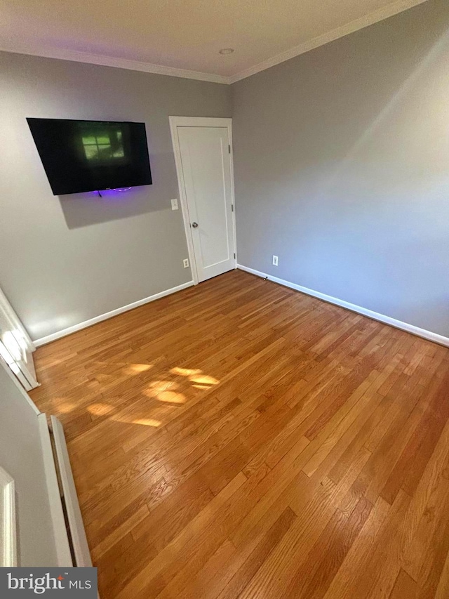 interior space with hardwood / wood-style flooring and ornamental molding