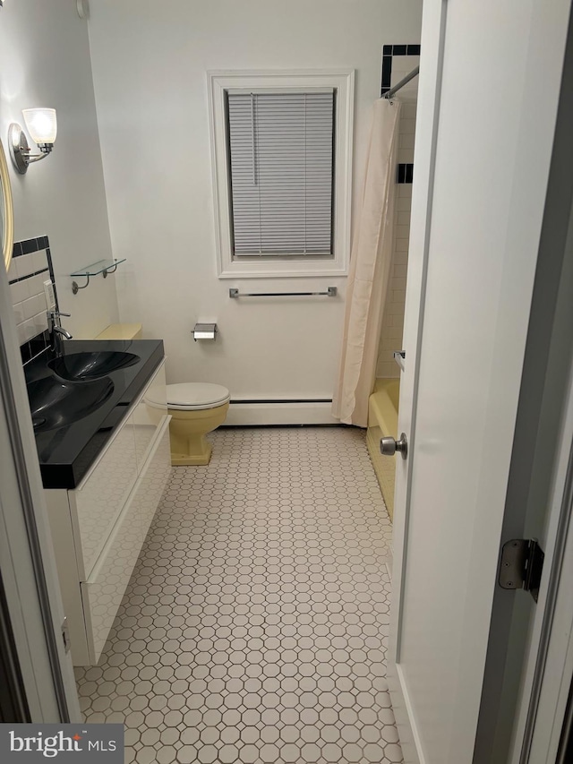 full bathroom with shower / bath combo, baseboard heating, vanity, tile patterned floors, and toilet