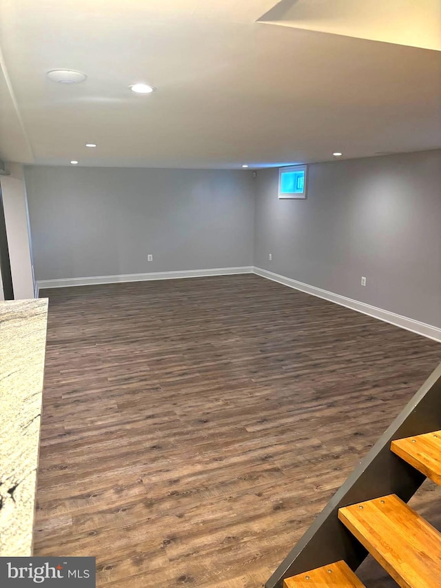 basement with dark wood-type flooring