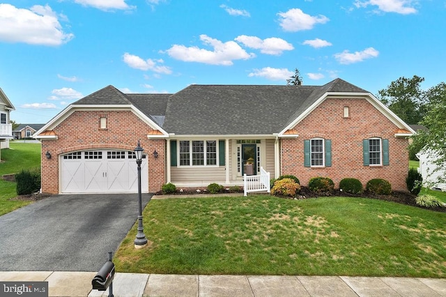 view of front of property with a front yard and a garage