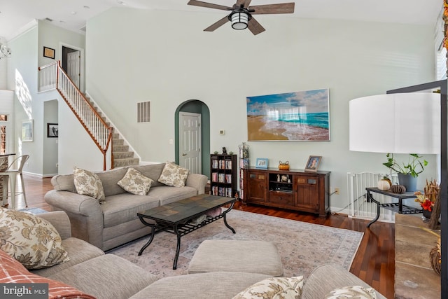 living room with ceiling fan, dark hardwood / wood-style floors, high vaulted ceiling, and plenty of natural light