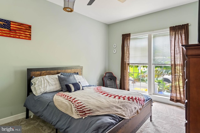 bedroom featuring light carpet, multiple windows, and ceiling fan