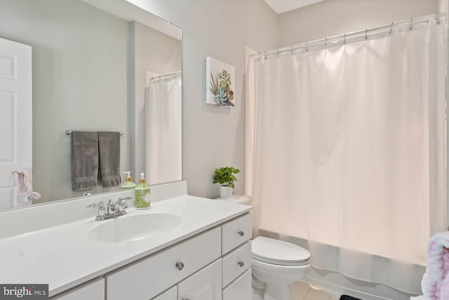 full bathroom with shower / tub combo, tile patterned flooring, vanity, and toilet