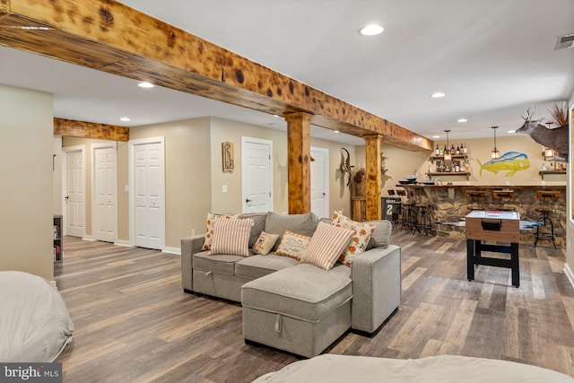 living room featuring hardwood / wood-style flooring and bar area