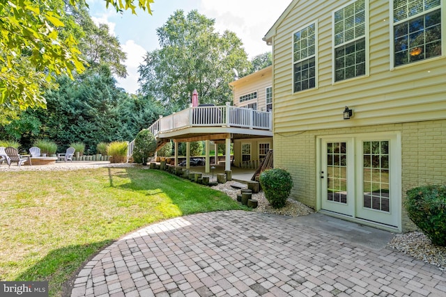 view of patio / terrace with a wooden deck and a fire pit