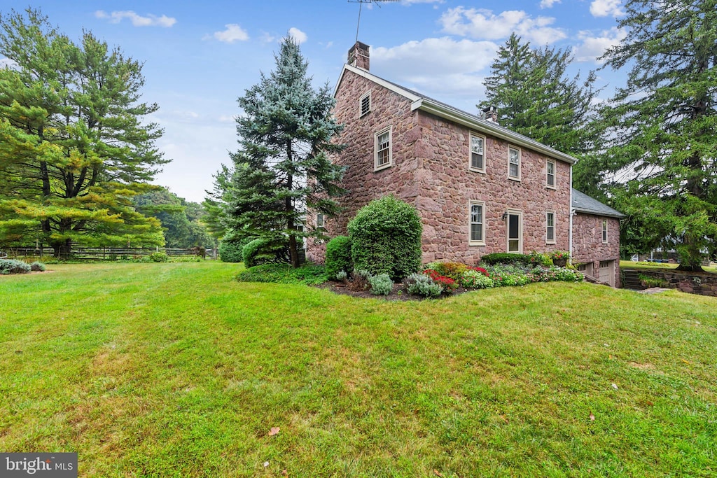 view of side of home with a lawn