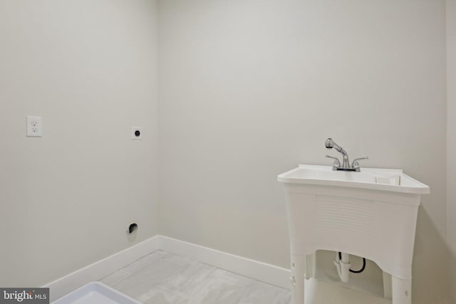 laundry room with light tile patterned flooring, hookup for an electric dryer, and sink