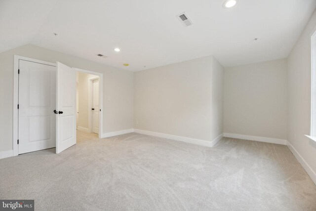 additional living space with lofted ceiling and light colored carpet