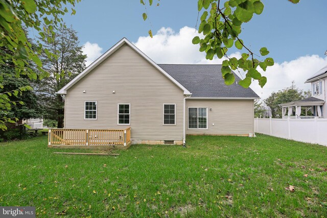 rear view of house with a lawn and a gazebo