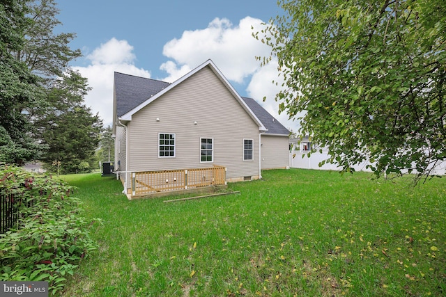 back of property with a lawn and central AC unit