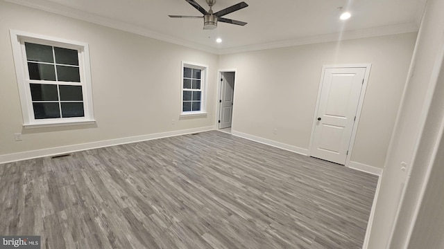 spare room with ceiling fan, crown molding, and wood-type flooring