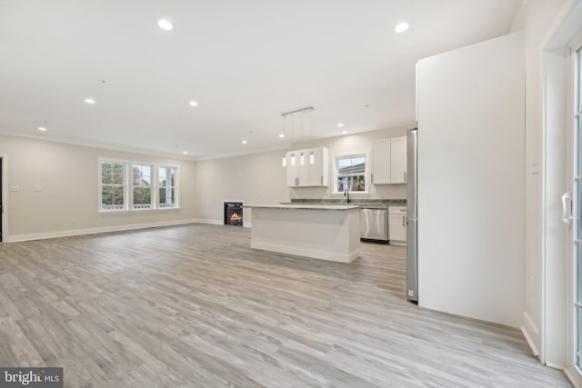 43 Bennett Ave, Westminster, MD 21157 - unfurnished living room featuring crown molding, recessed lighting, baseboards, a sink, and light wood-style flooring