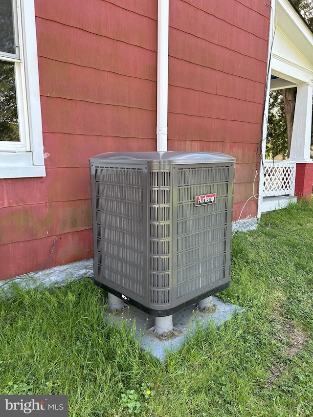 exterior details with wood walls and central air condition unit