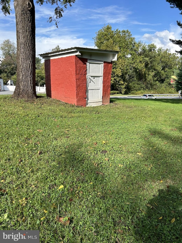 view of outbuilding with a lawn