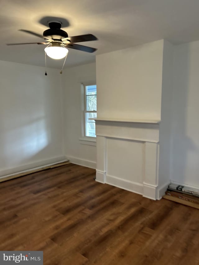 spare room featuring dark hardwood / wood-style floors and ceiling fan