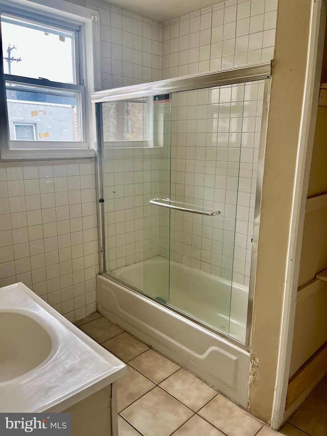 bathroom featuring vanity, enclosed tub / shower combo, and tile patterned floors