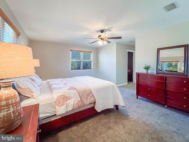 bedroom with carpet flooring, multiple windows, and ceiling fan