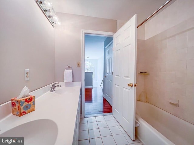 bathroom featuring hardwood / wood-style flooring, vanity, and tiled shower / bath combo