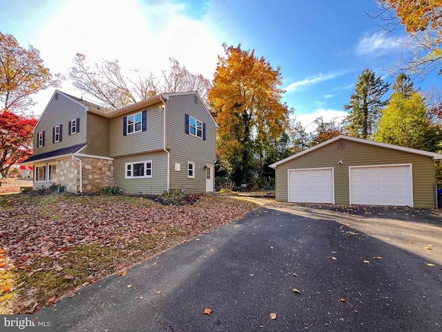 view of side of home with a garage and an outdoor structure